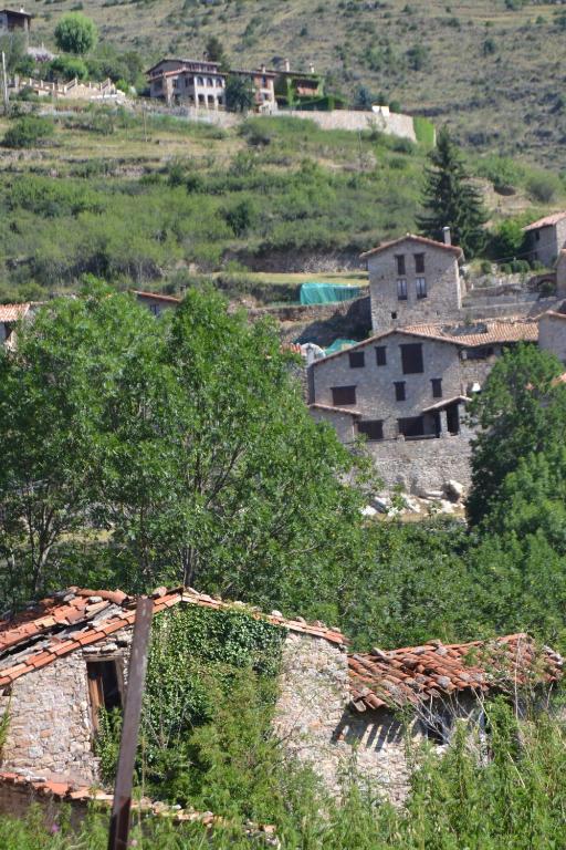 a group of houses on top of a hill at Hostal La Muntanya in Castellar de NʼHug