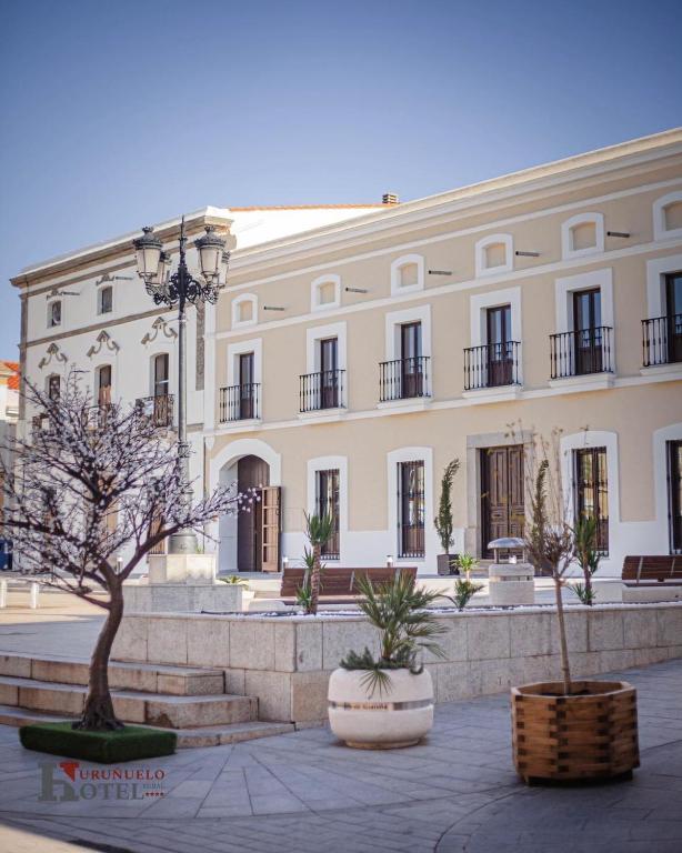 a large white building with a tree in front of it at Hotel Rural el Turuñuelo in Guareña