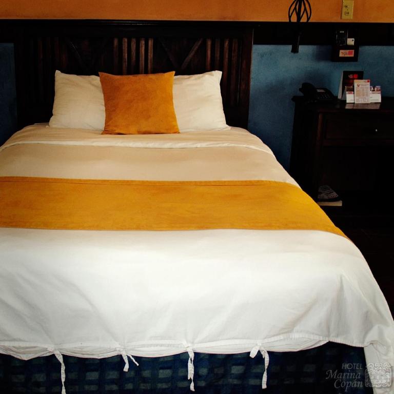 Postel nebo postele na pokoji v ubytování Hotel Marina Copan