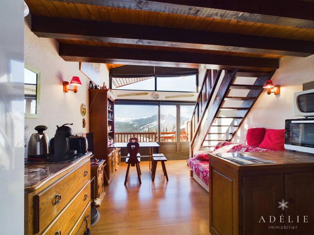 un salon avec un escalier menant à un salon dans l'établissement Studio avec mezzanine pour 4 pers, proche commerces et remontées - FR-1-398-677, à Montvalezan