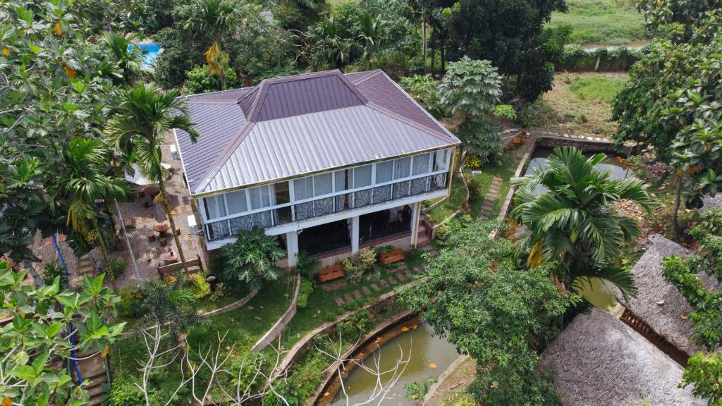 an aerial view of a house in the jungle at Ciudad Caliente by The Lavana in Talisay