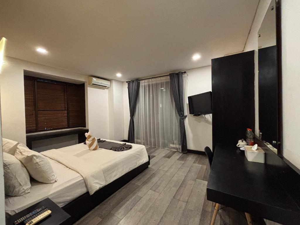 Postel nebo postele na pokoji v ubytování Hotel ARA Legian