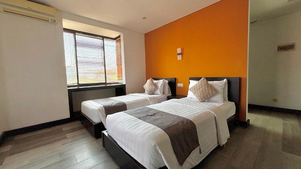 Postel nebo postele na pokoji v ubytování Hotel ARA Legian