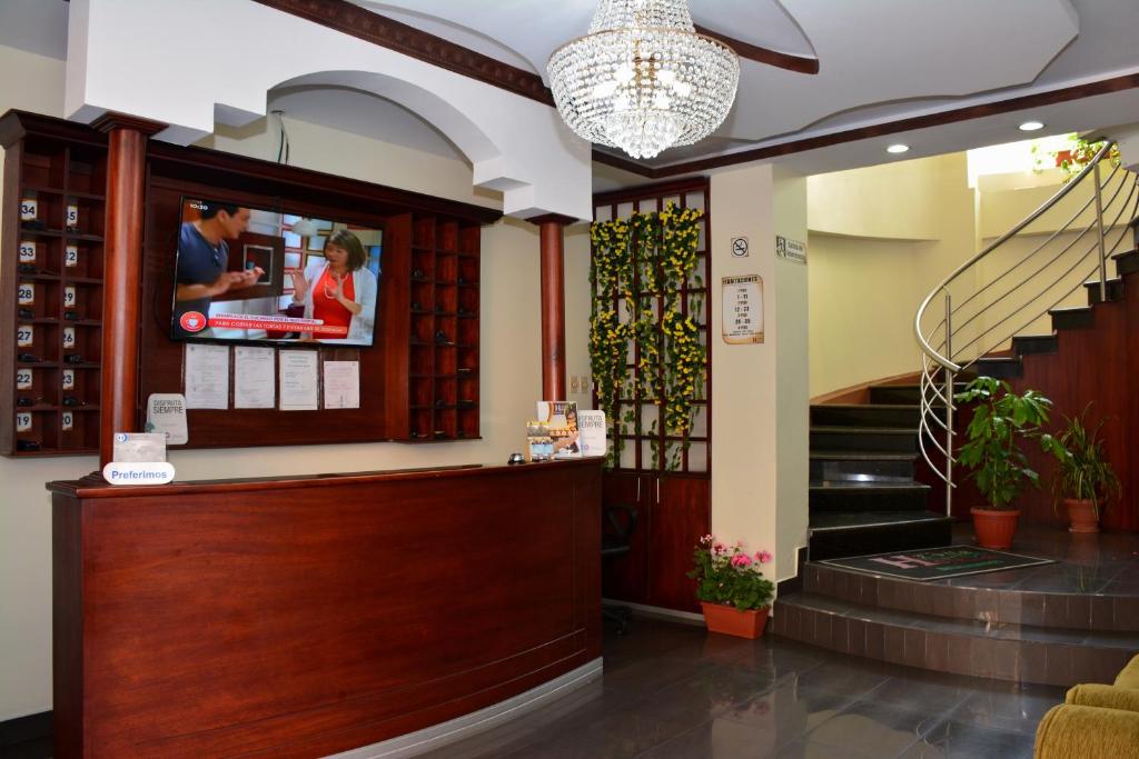 a lobby with a tv on the wall at Hotel Elvita Spa in Baños