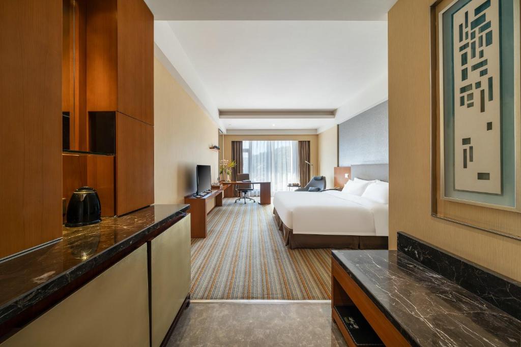 Postel nebo postele na pokoji v ubytování Juntai Hotel Xiamen