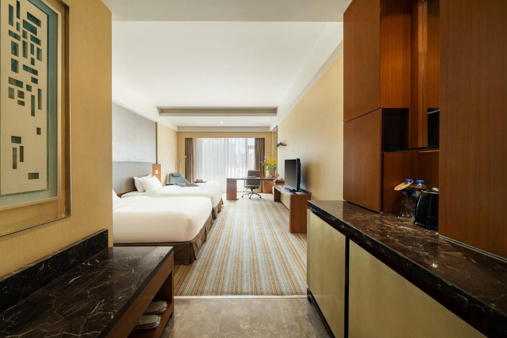 Postel nebo postele na pokoji v ubytování Juntai Hotel Xiamen