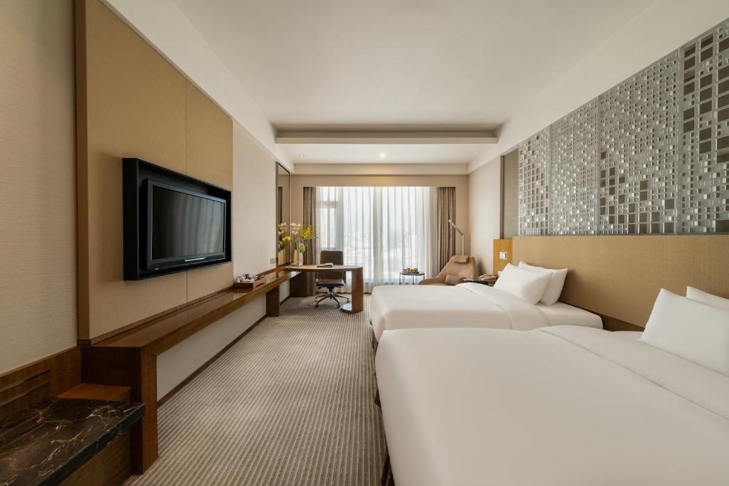 Postel nebo postele na pokoji v ubytování Juntai Hotel Xiamen
