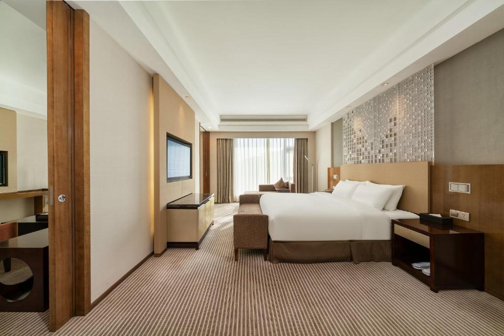 Postel nebo postele na pokoji v ubytování Juntai Hotel Xiamen