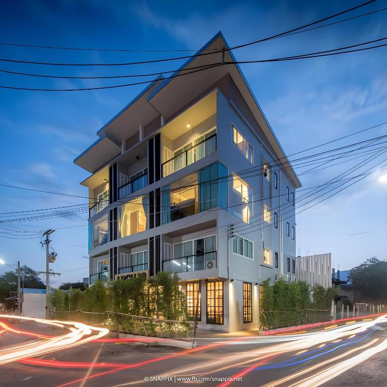 a building on the corner of a street at Mandalar Arch 39 Hotel in Chiang Mai