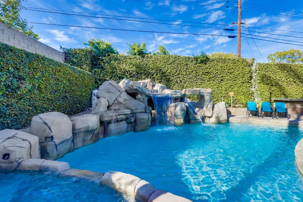 a water slide in a pool with a waterfall at Destination #48 in Placentia
