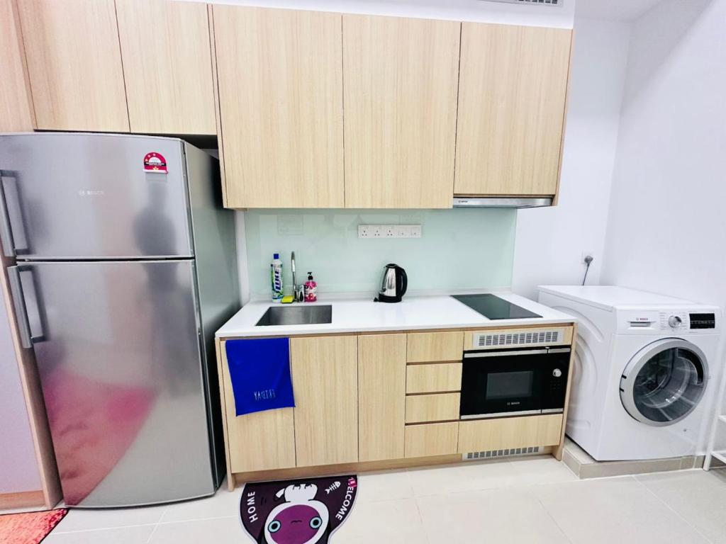 a small kitchen with a refrigerator and a dishwasher at THE LUXE INFINITUM RESIDENCE at KL CITY in Kuala Lumpur