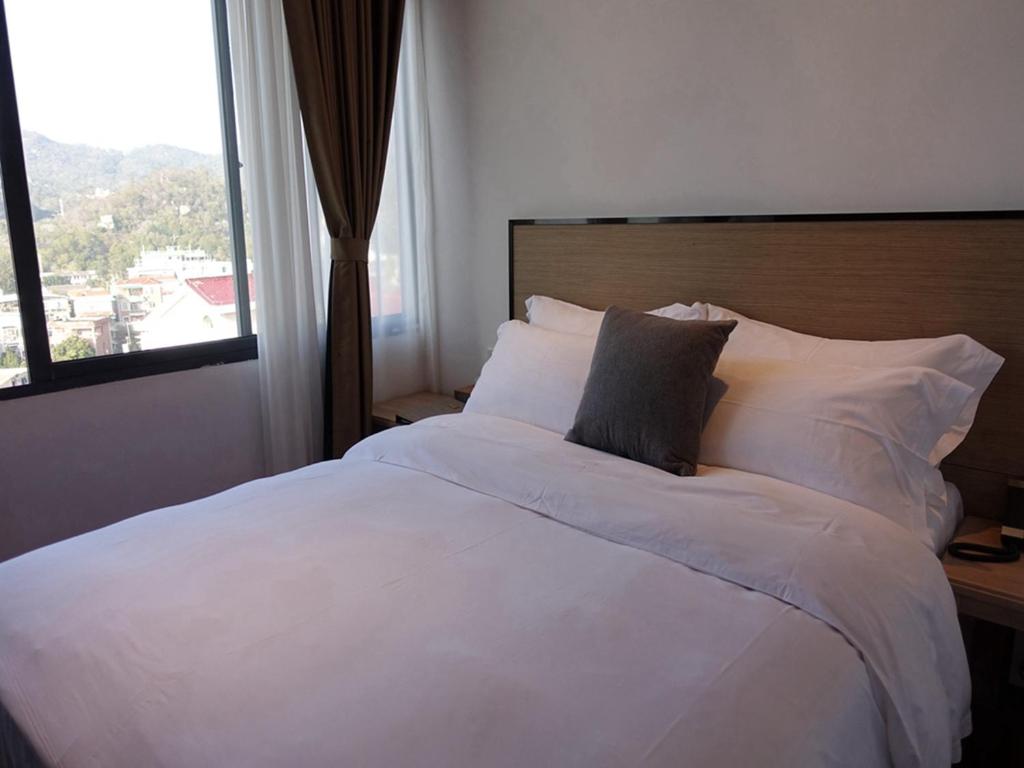 Postel nebo postele na pokoji v ubytování Xiamen Wujing Mountain and Sea View Hotel