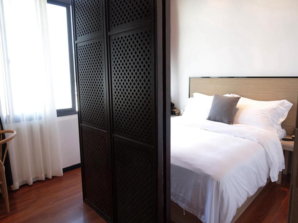 Postel nebo postele na pokoji v ubytování Xiamen Wujing Mountain and Sea View Hotel
