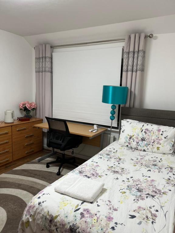 a bedroom with a bed and a desk with a computer at House in city centre with free parking in Cambridge