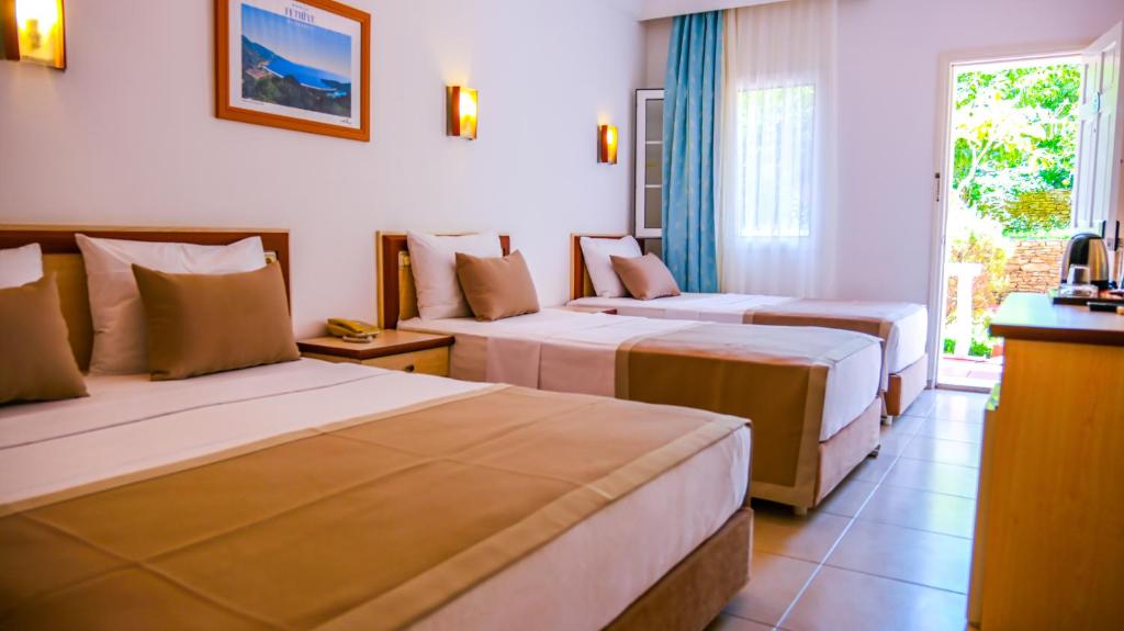 A bed or beds in a room at Ölüdeniz Turquoise Hotel - All Inclusive