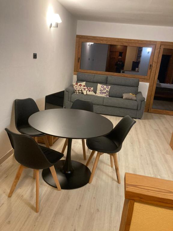a living room with a table and chairs and a couch at Cielo Alto I Dadi in Breuil-Cervinia