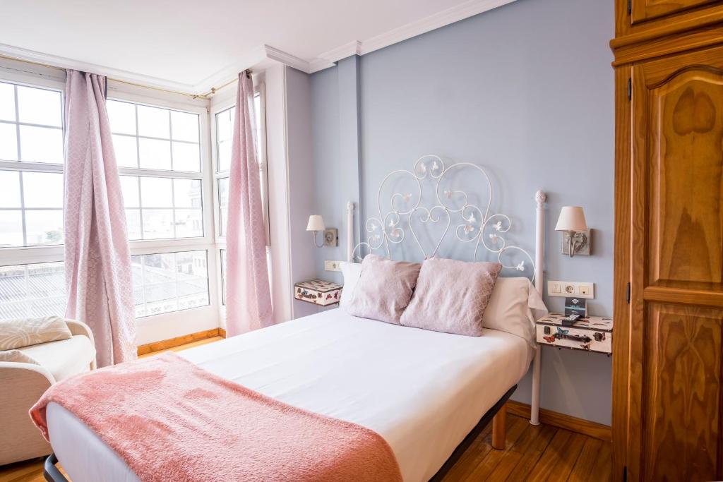 a bedroom with a large bed with a white bed frame at InsideHome Porta do Sol in Vigo