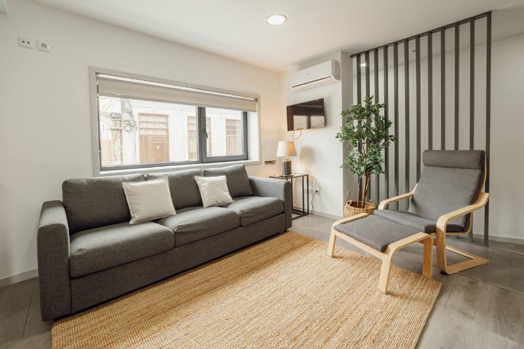 a living room with a couch and a chair at Amazing Villa by Hosty in Porto