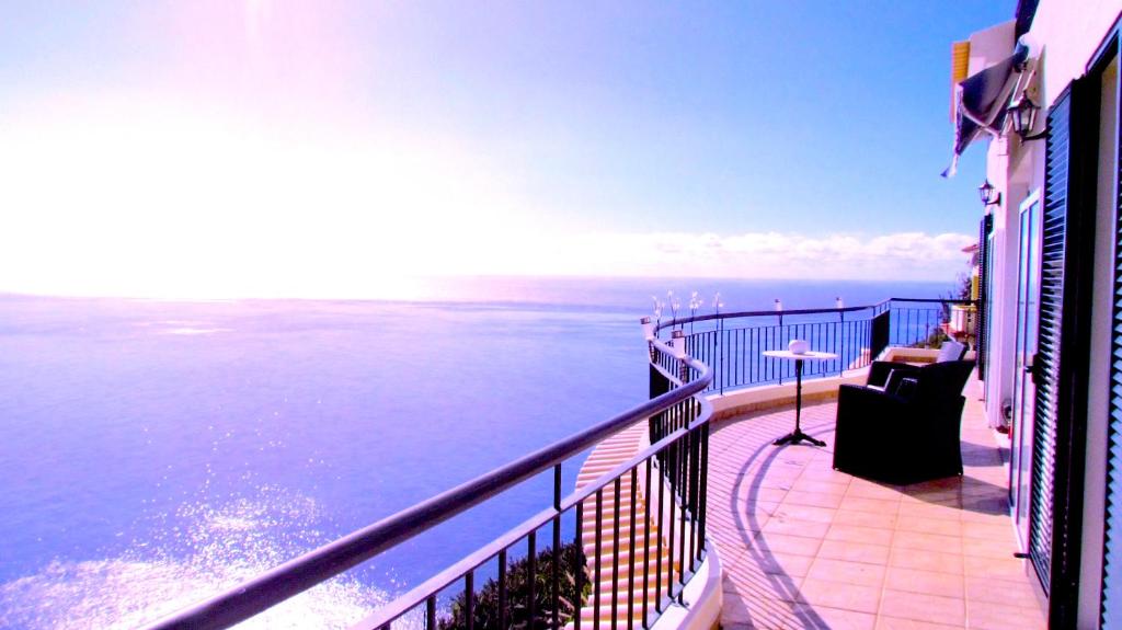 a balcony with a view of the ocean at Casa Serena Apartments in Arco da Calheta
