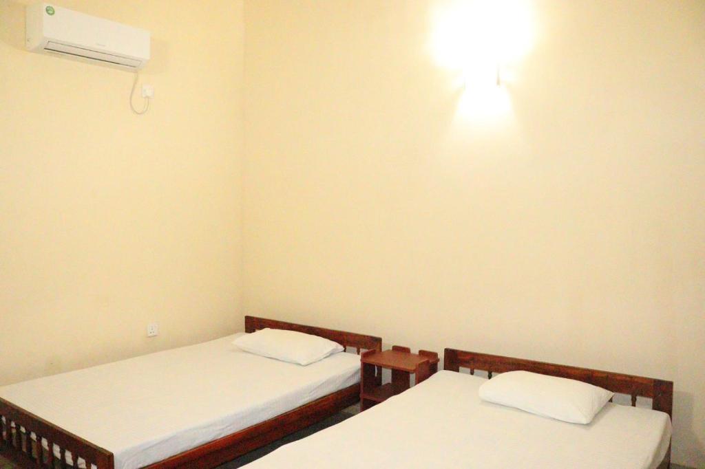 Postel nebo postele na pokoji v ubytování Sunshine Guest House