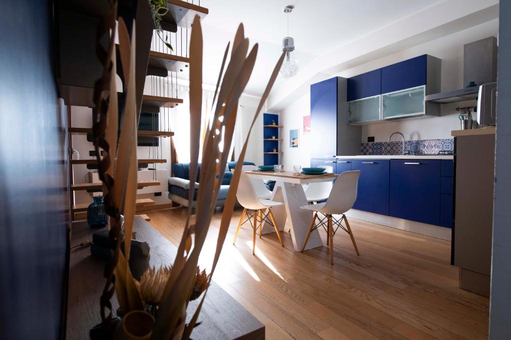 una cucina con armadi blu, tavolo e sedie di La Casa di Oliviero a Vetralla