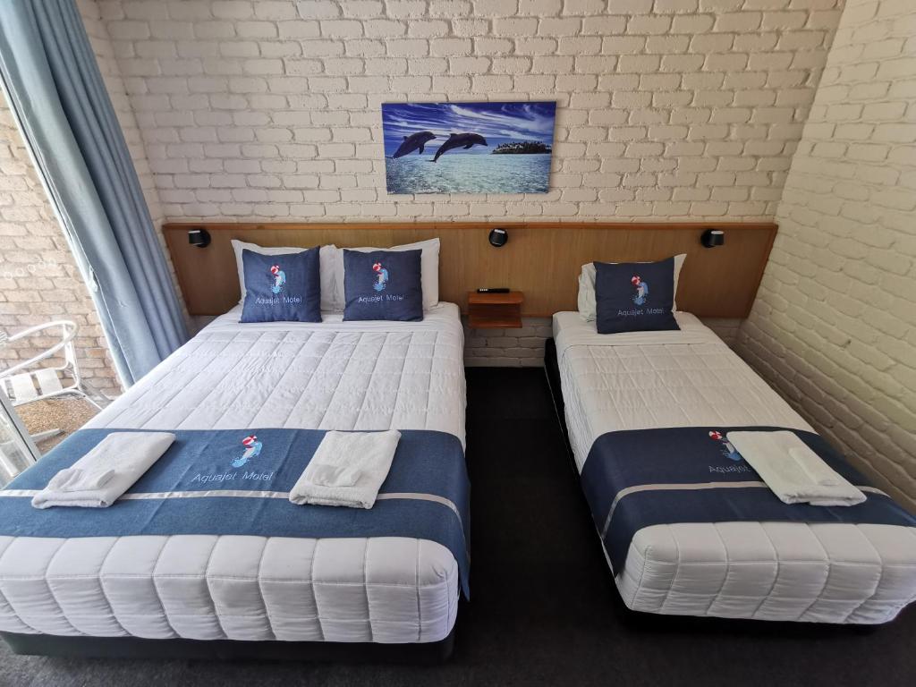 Postel nebo postele na pokoji v ubytování Aquajet Motel