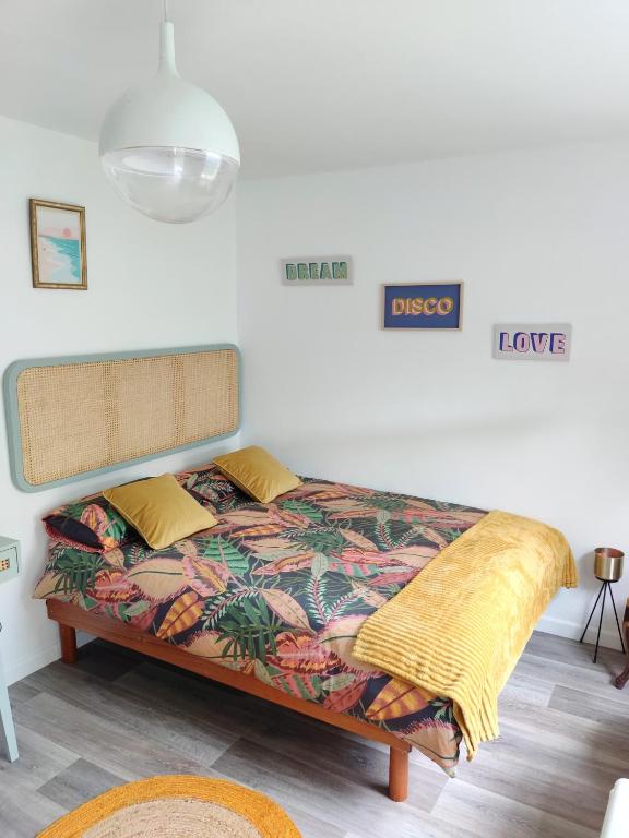 a bedroom with a bed with a colorful blanket at Casilda y Villamil Playa de Patos & Camino de Santiago in Nigrán