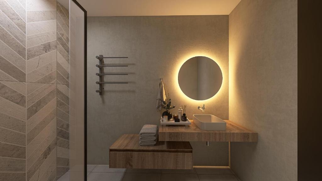 a bathroom with a sink and a mirror at South Coast Hotel in Makry Gialos