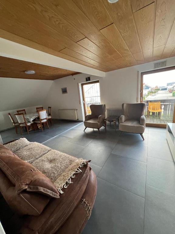 a living room with a couch and chairs and a table at Mira Home in Murg