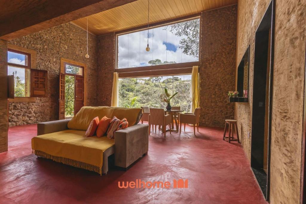 a living room with a couch and a table at Casa na pedra em Serra Negra vista para montanha in Bezerros