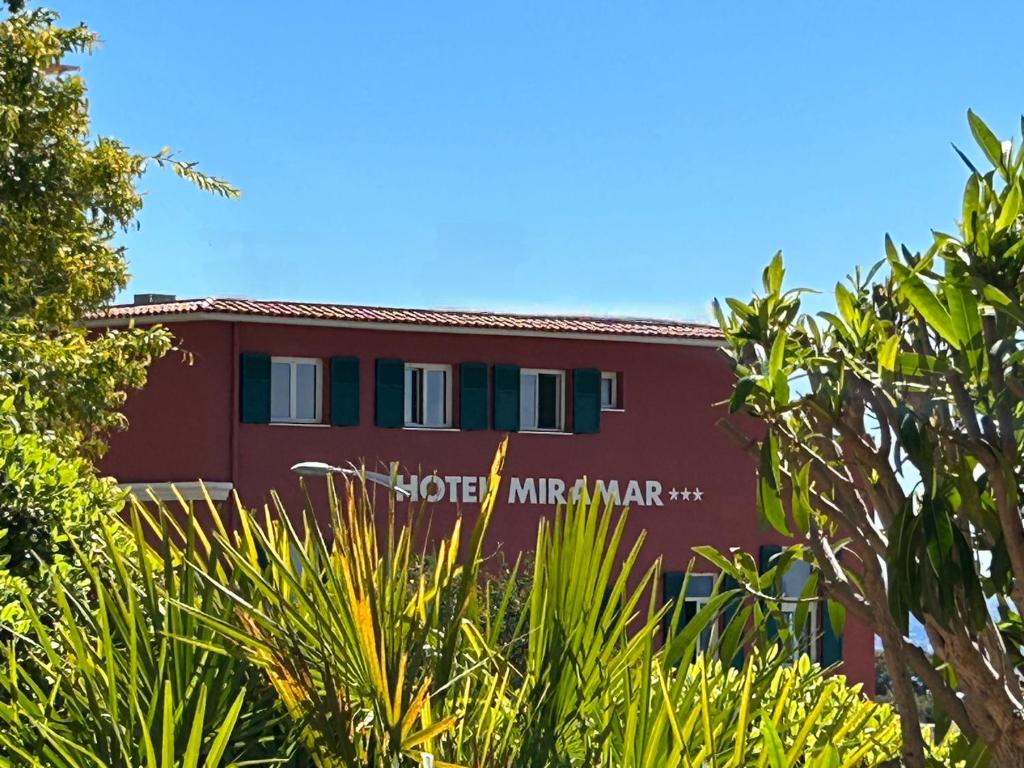 a red building with the words sore michelle ann at Hotel Miramar in Cap d'Ail