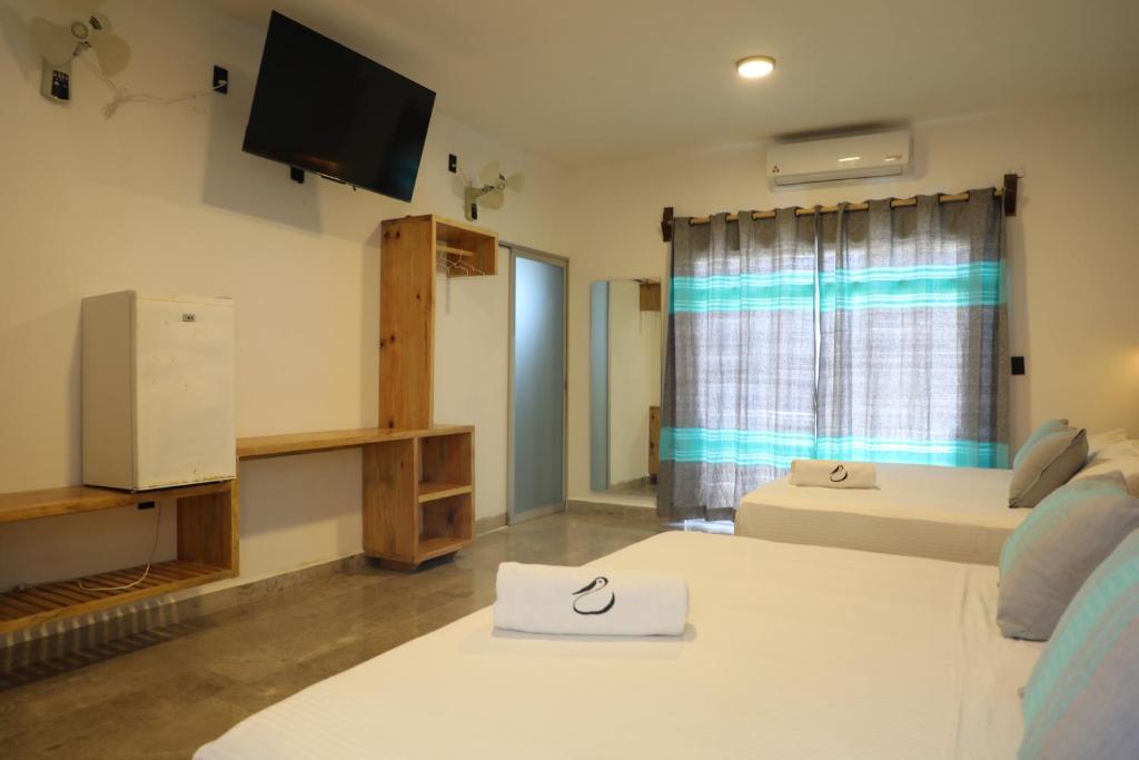 Postel nebo postele na pokoji v ubytování Hotel Playa Zipolite