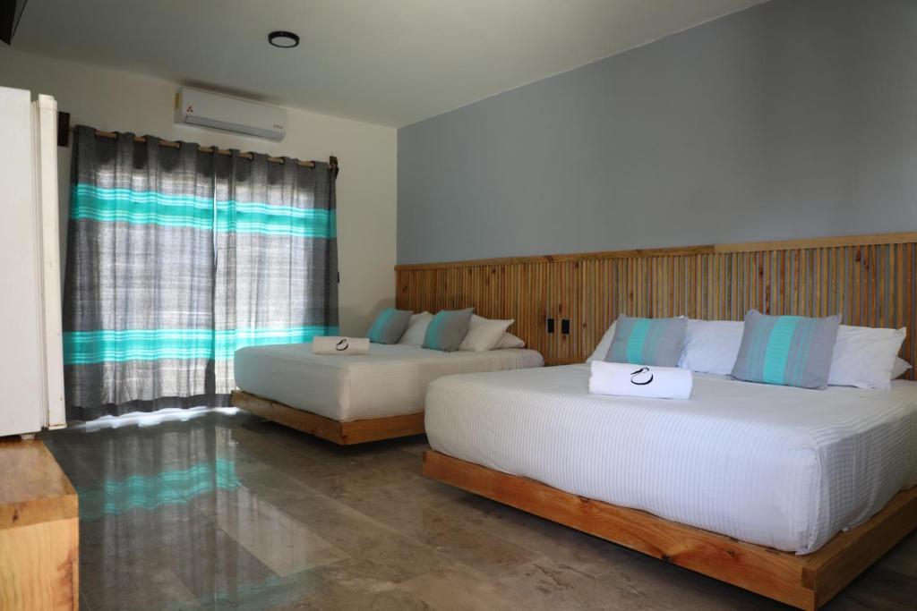 Postel nebo postele na pokoji v ubytování Hotel Playa Zipolite