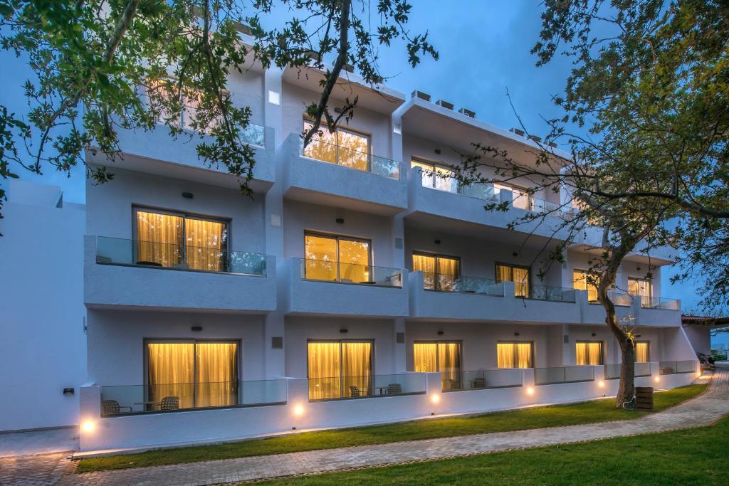 a building with lights in front of it at South Coast Hotel in Makry Gialos