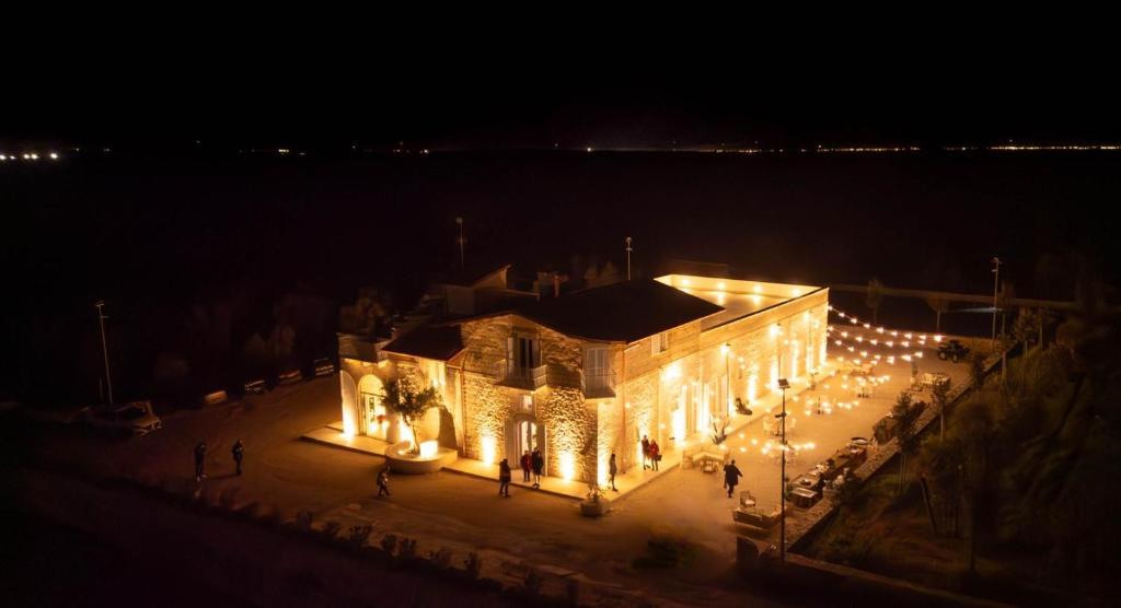 a building lit up at night with lights at Masseria Finigrini Luxury in Corato