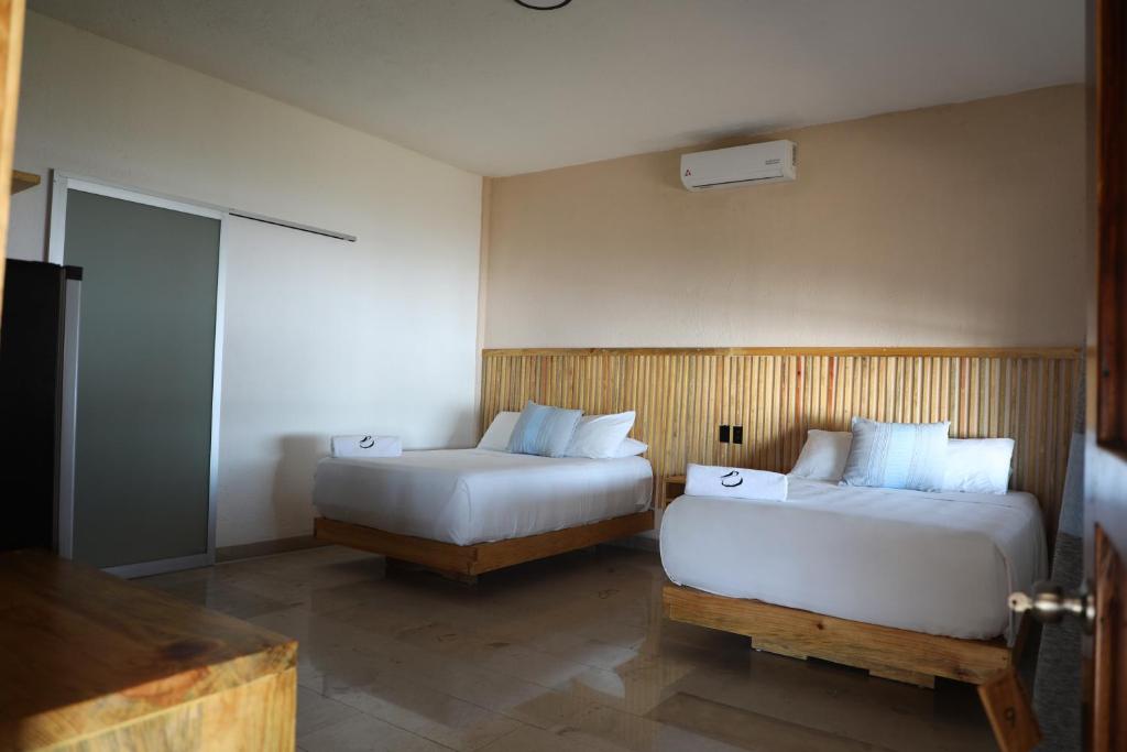 Postel nebo postele na pokoji v ubytování Hotel Playa Zipolite