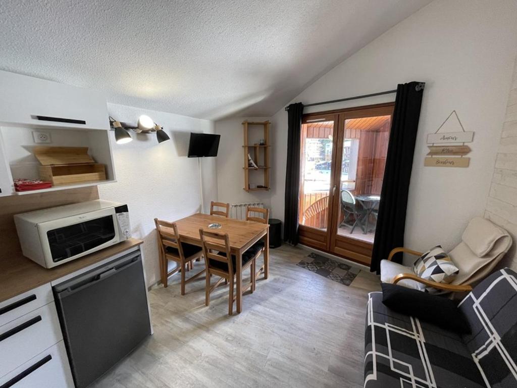 une cuisine et une salle à manger avec une table et des chaises dans l'établissement Appartement fonctionnel 4.5 pers, proche pistes et commerces, balcon exposé Sud-Est - FR-1-787-82, à Laveissière