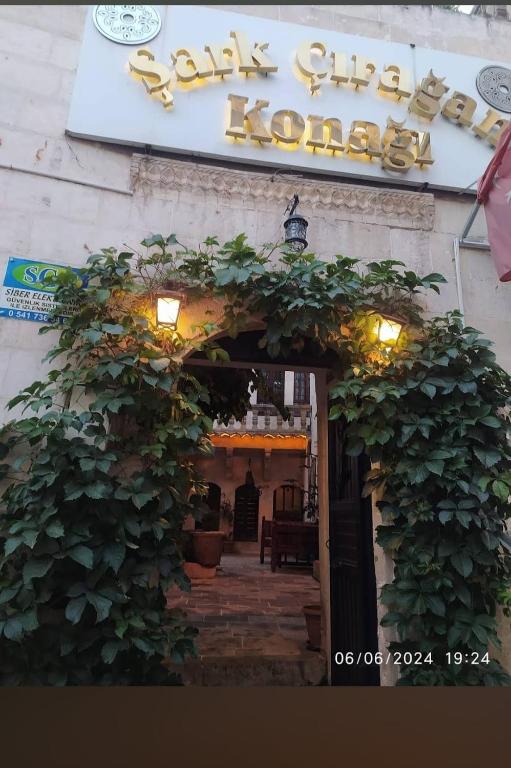 an entrance to a restaurant with a sign on a building at Şark Çırağan Konak Boutique Hotel in Urfa