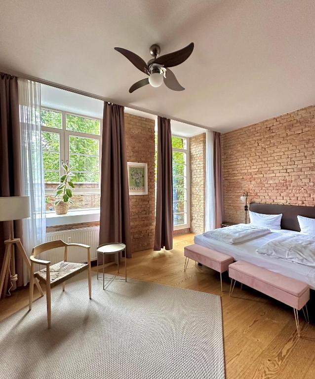 a bedroom with a bed and a brick wall at cinderella.kreuzberg in Berlin
