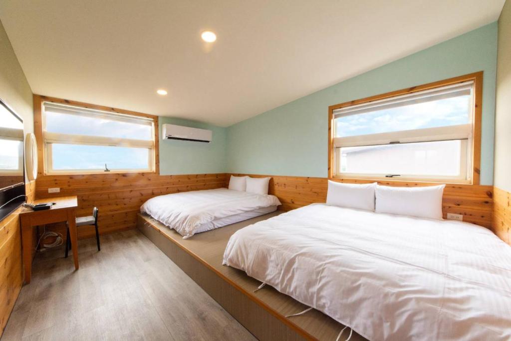 Postel nebo postele na pokoji v ubytování 峰樹屋