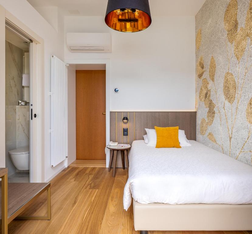 Voodi või voodid majutusasutuse Hotel Walter Au Lac toas