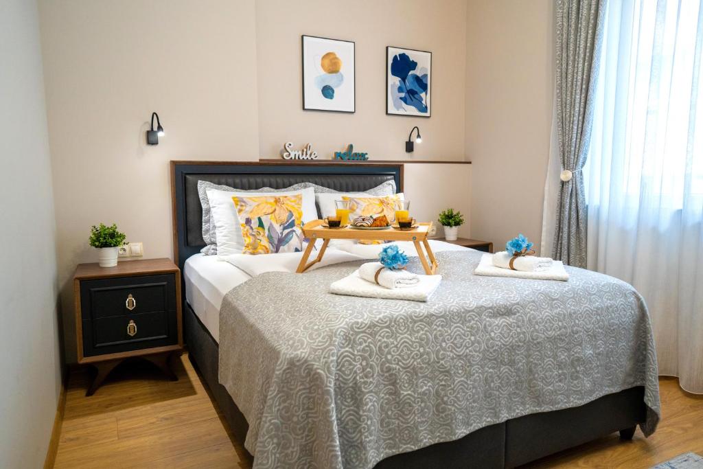 a bedroom with a bed with two towels on it at SP Urban Apartment in Plovdiv