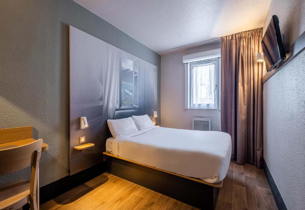 Postel nebo postele na pokoji v ubytování B&B HOTEL Annecy Argonay