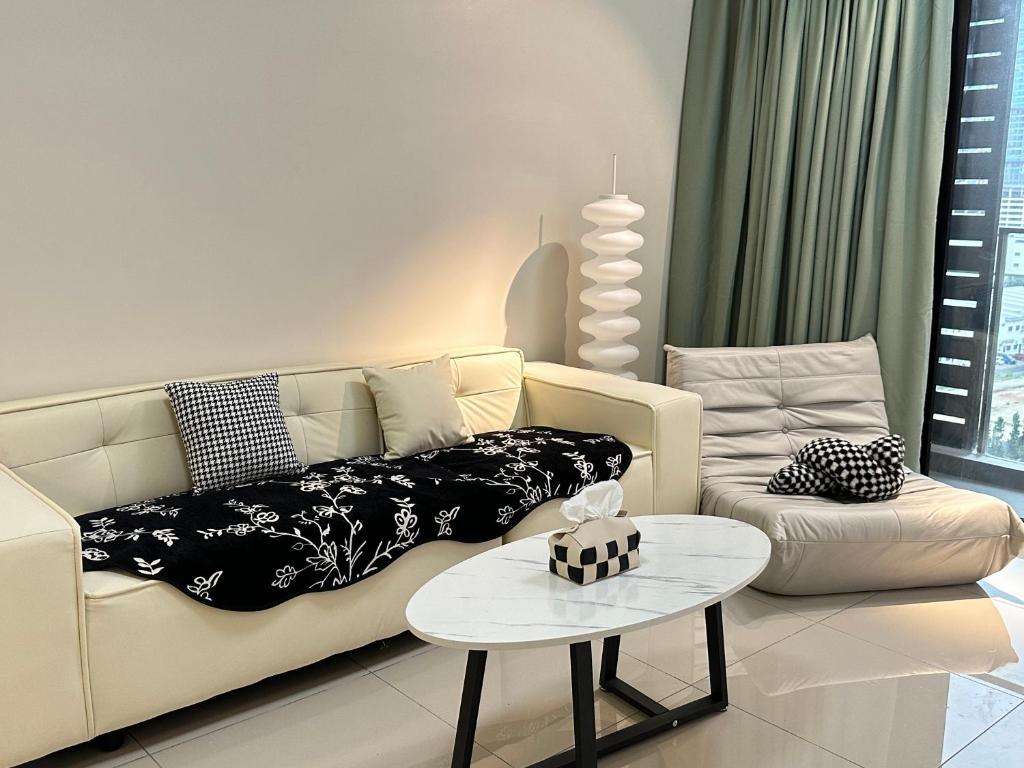 a living room with a couch and a table at Admiral 3-Bedroom Retreat in Kota Laksamana Jonker in Melaka