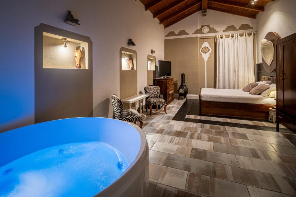 a bathroom with a tub and a bedroom with a bed at Le Meraviglie di Alice in Cagliari