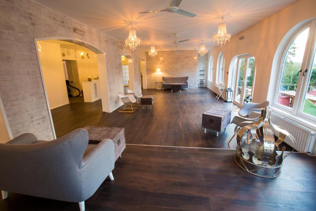 a large living room with a couch and a table at Gray Manor Hotel in Cholderton