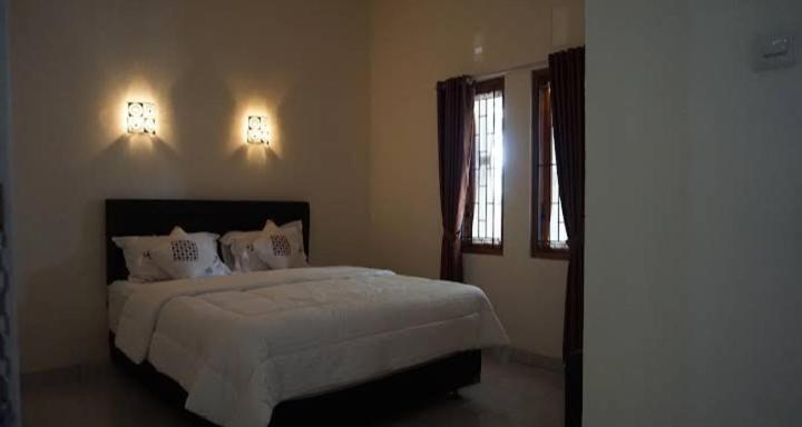 Ένα ή περισσότερα κρεβάτια σε δωμάτιο στο Alisari homestay