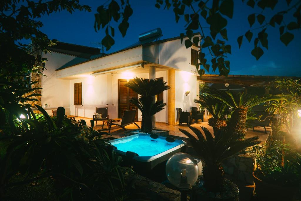 a villa with a swimming pool at night at VillaThomas in Campofelice di Roccella