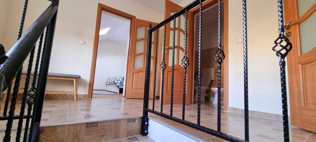 a staircase with black iron railings in a house at Casa in centrul Zalaului in Zalău