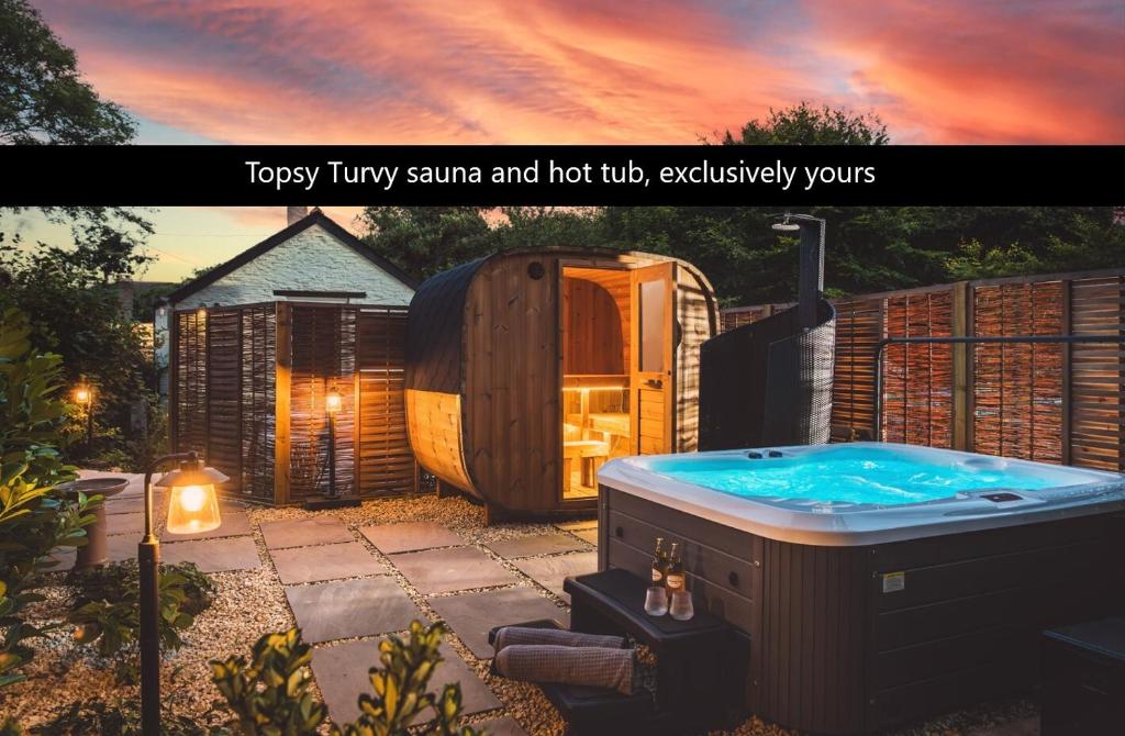 una foto de una bañera de hidromasaje en un patio trasero en Topsy Turvy and Hillside Spa at Tregoose Old Mill, en Newquay